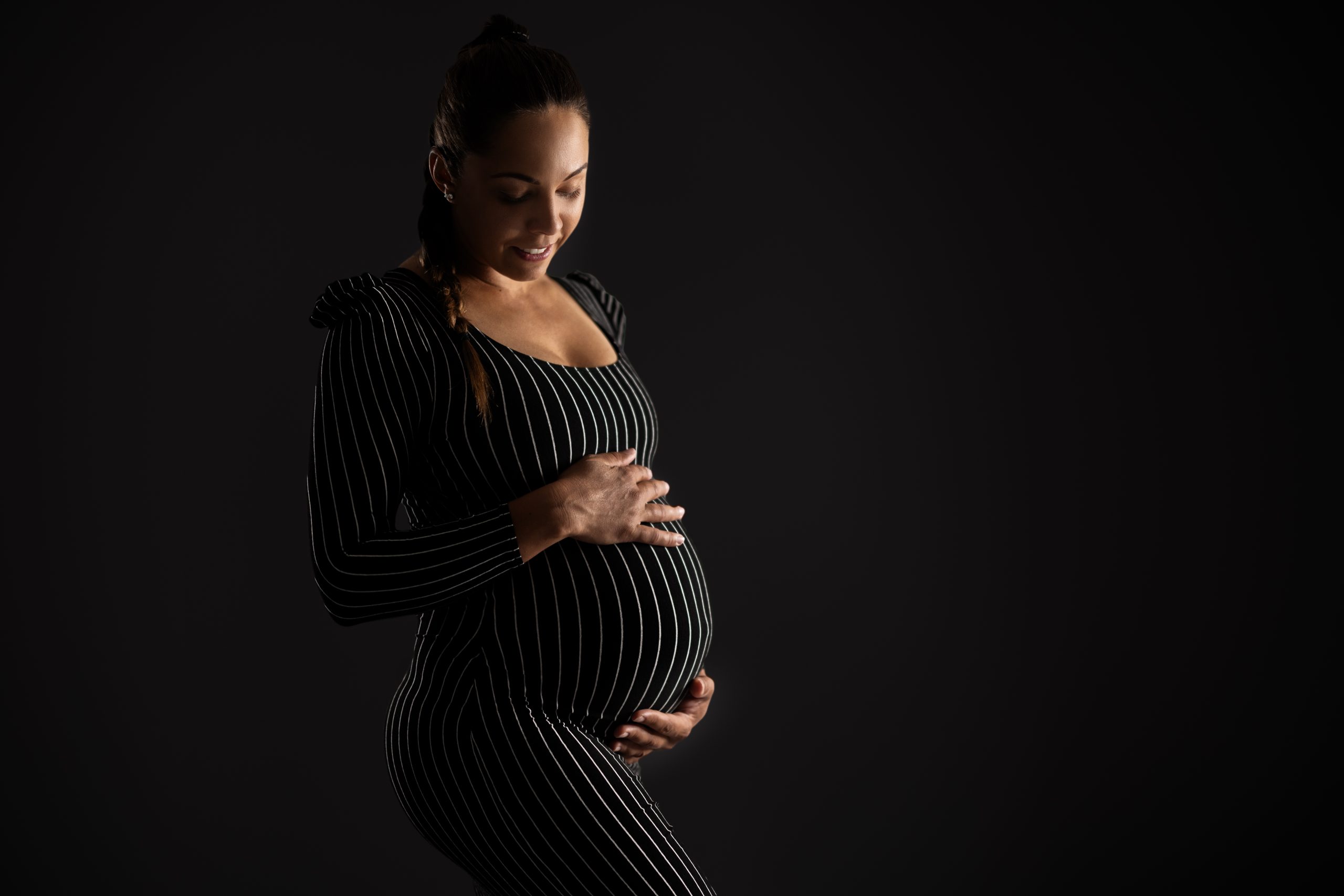 smiling pregnant woman in striped dress with black 2023 11 27 05 29 09 utc scaled